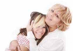 Mother hugging daughter